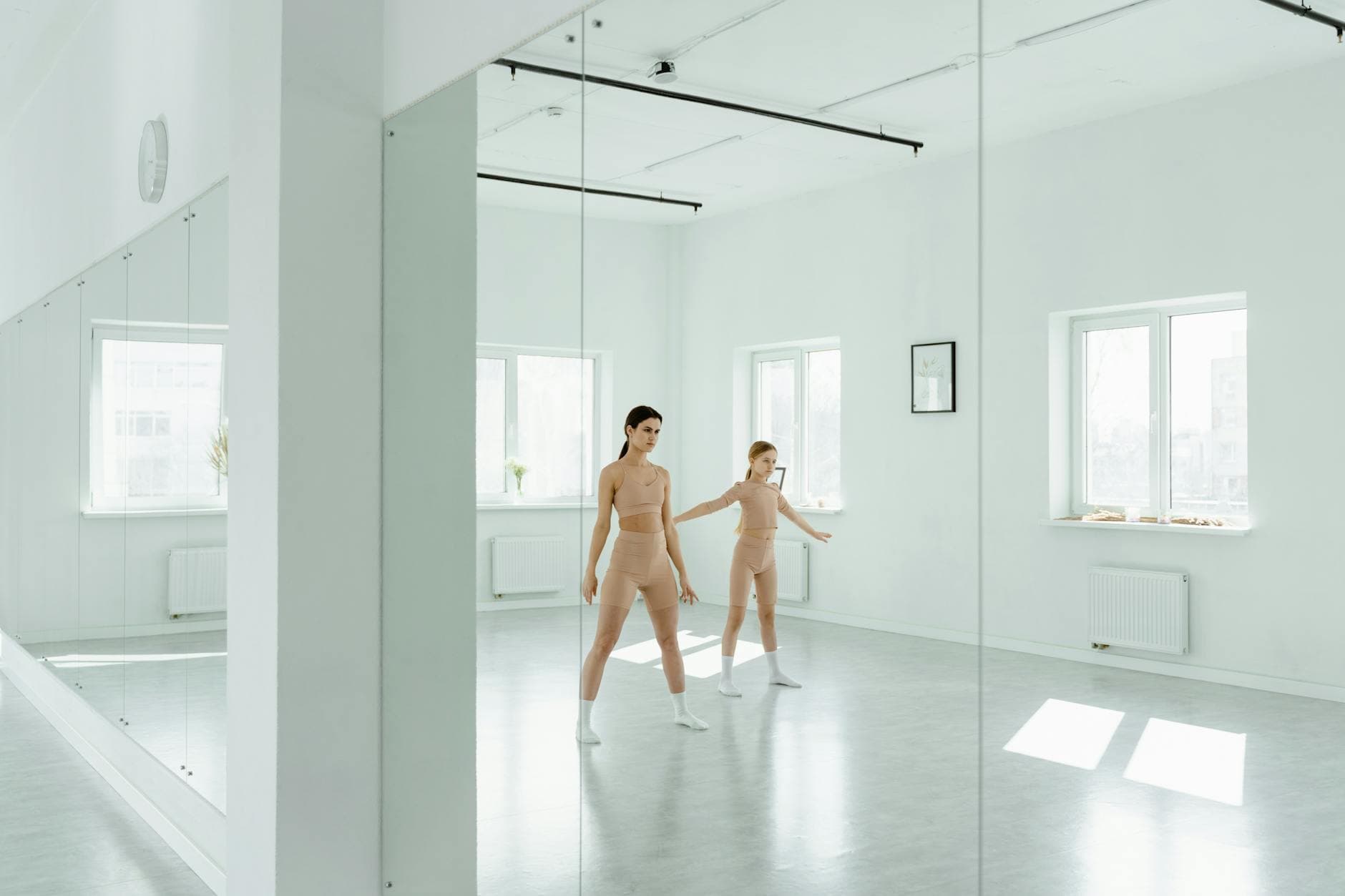Dancers rehearsing in a mirrored studio